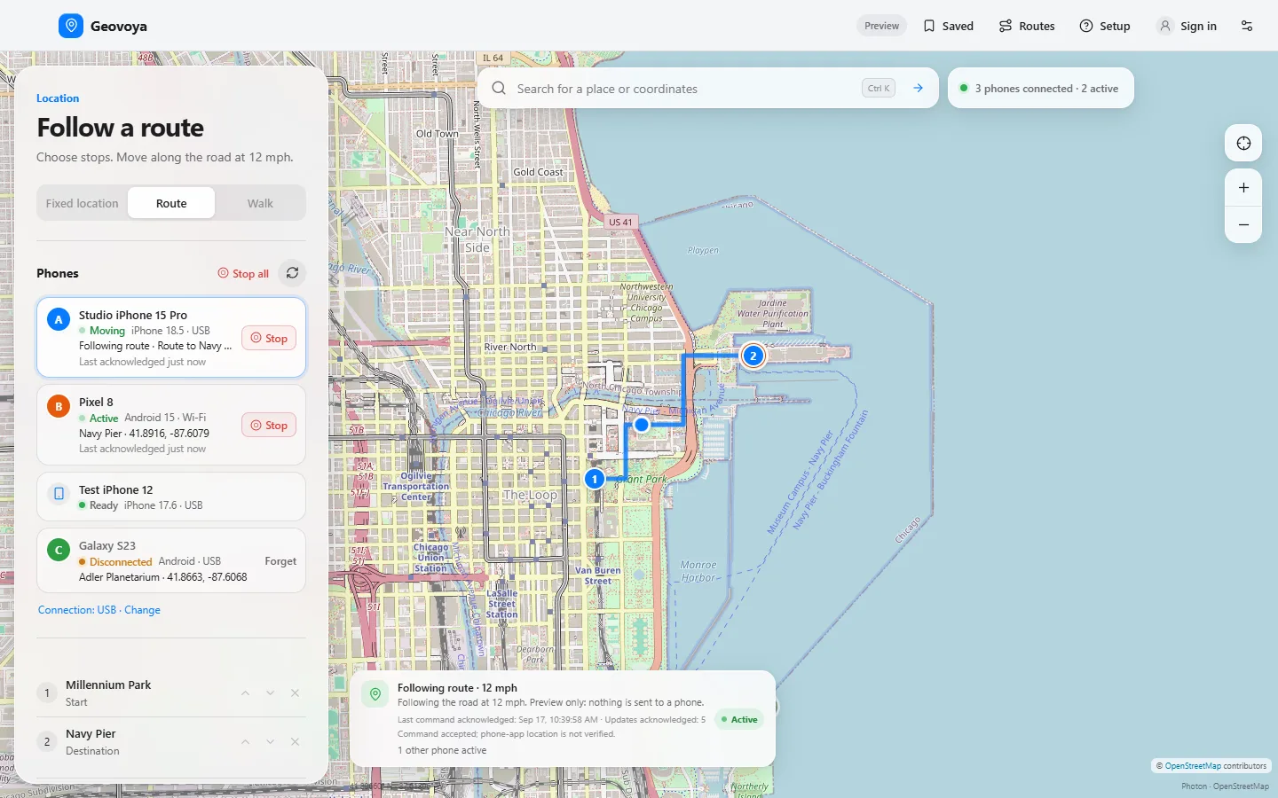 Geovoya controlling several phones: the phone list shows a Studio iPhone 15 Pro following a route at 12 mph, a Pixel 8 active at Navy Pier over Wi-Fi, a ready Test iPhone 12 and a disconnected Galaxy S23; the map shows the route and lettered markers.